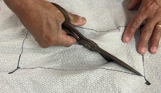 Cutting fabric opening along marked border line for Viraport installation